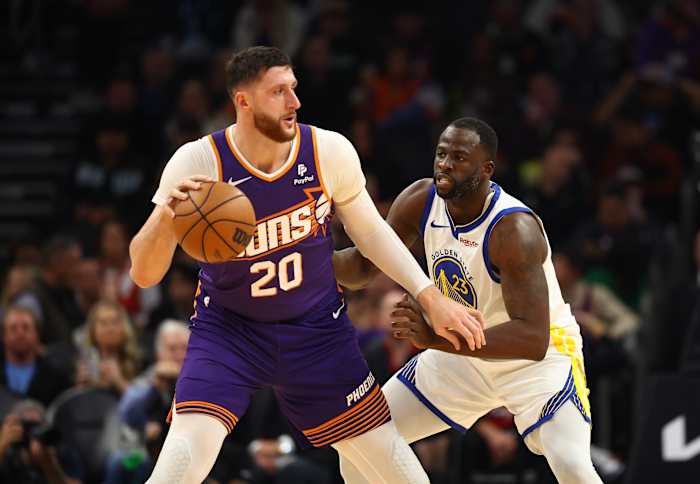 Golden State Warriors forward Draymond Green defends against Phoenix Suns center Jusuf Nurkić